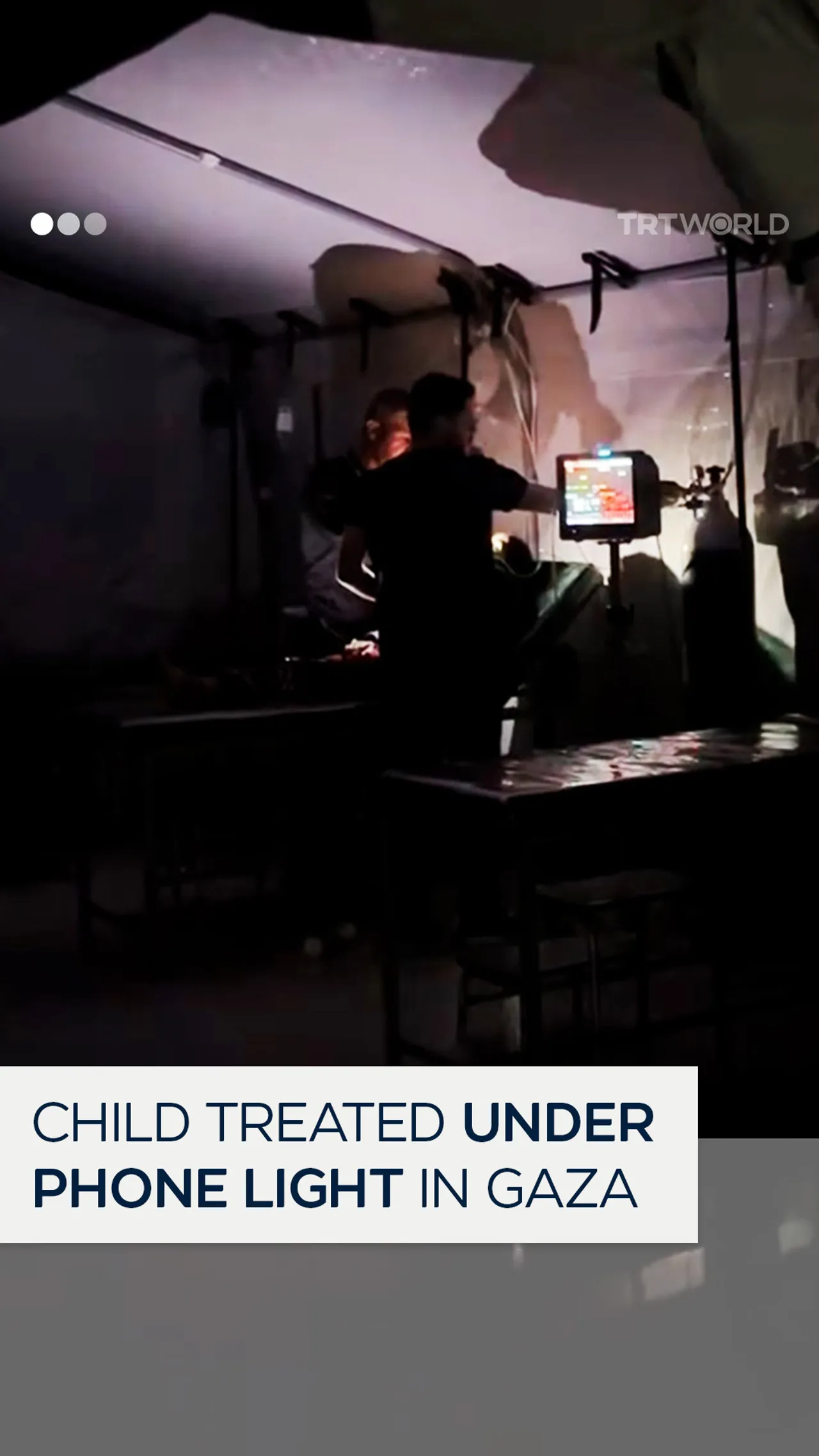 Child treated under phone light in Gaza